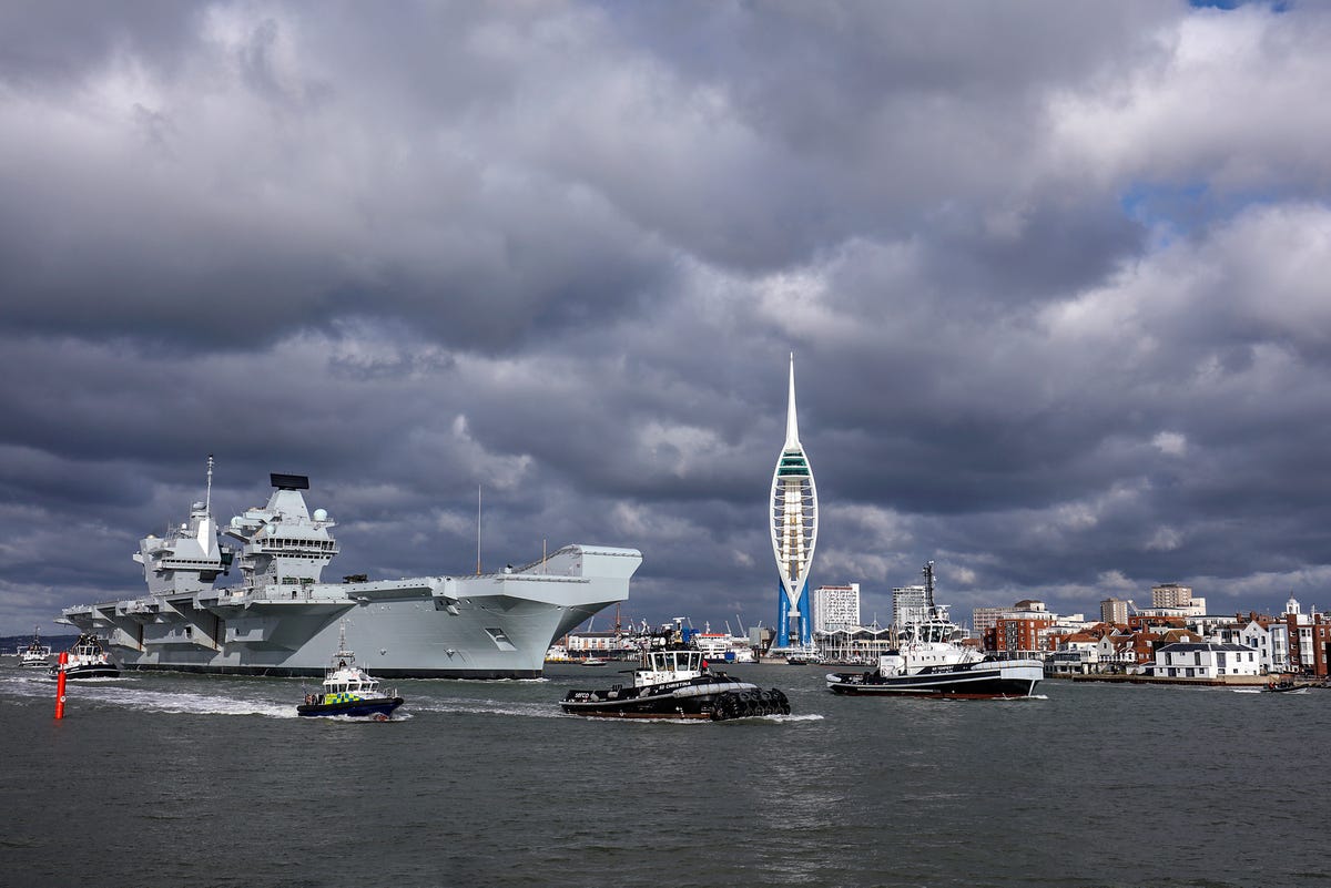 heres-the-carrier-heading-past-portsmouths-spinnaker-tower-with-tugboats-and-a-police-escort.jpg
