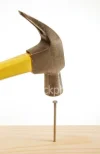ist2_2634771_hitting_a_nail_on_the_head.webp
