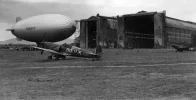 USN_blimp_with_RAAF_Spitfires_at_Cuers_Pierrefeu_1944.webp