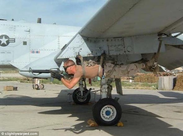 soldier-hangs-strapped-to-the-bomb-slot-of-a-jet.jpg