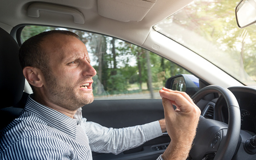 angry-italian-driver-gesturing-funny-road-rage-theme-picture-id891777202