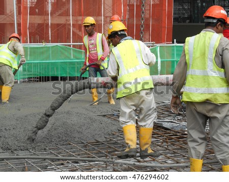 stock-photo-perak-malaysia-august-construction-workers-pouring-wet-concrete-using-hose-from-the-476294602.jpg